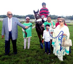 Trainer Narendra Lagad and Begum Sherbanoo leading in Red Merlot (Umesh up), winner of Waves of Glory Plate at Pune on Saturday.